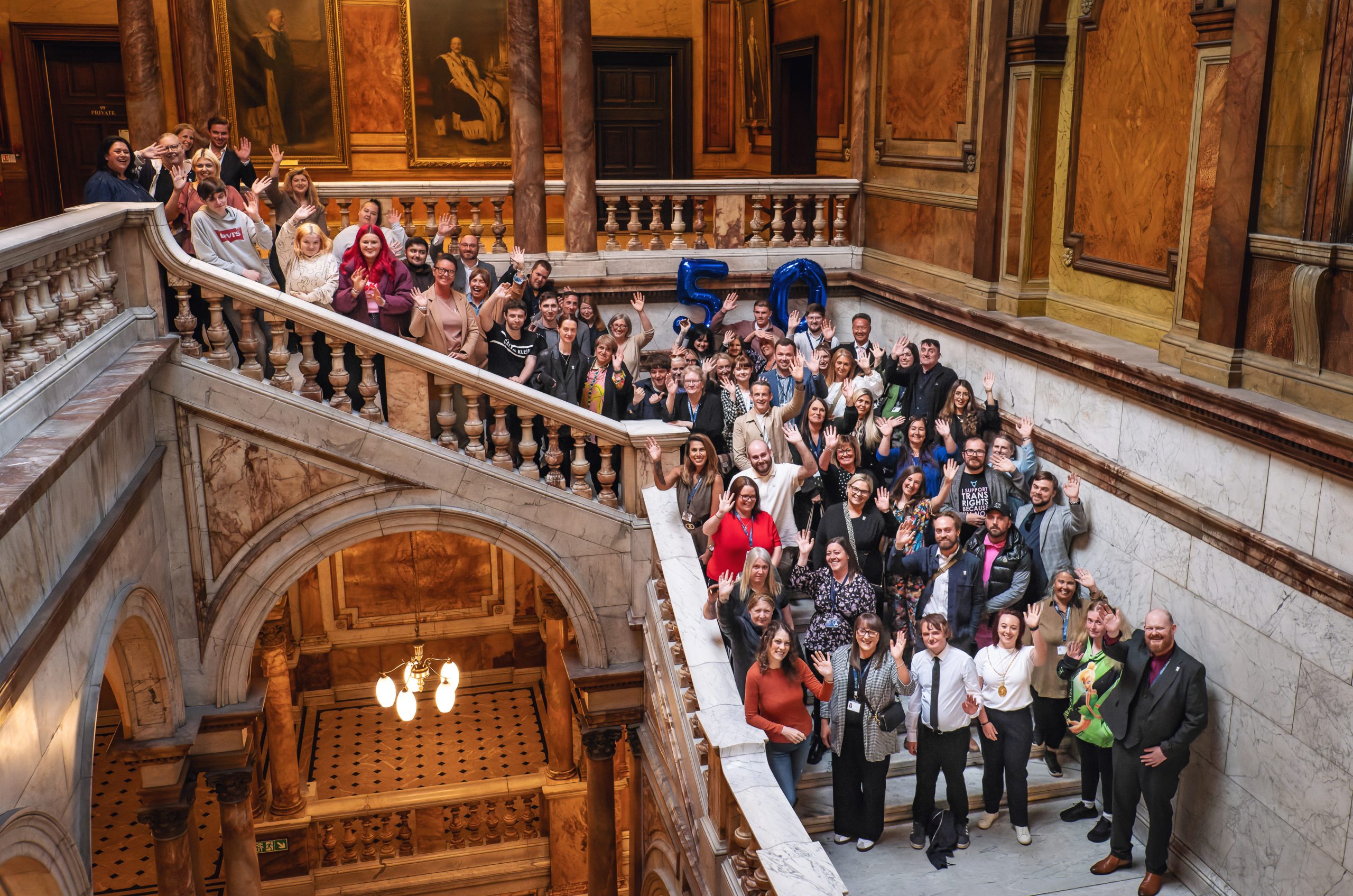 a photo of 50 plus people standing on a large stone staircase
